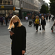 Woman stands in front of a McDonald's holding a phone